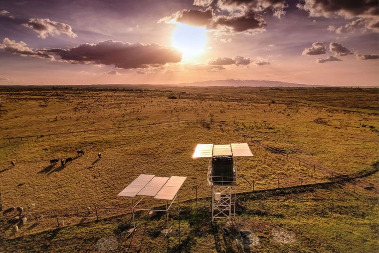 A solar-powered water pumping installation with storage tank at dusk